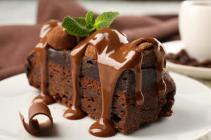 A piece of chocolate cake brownie with mint